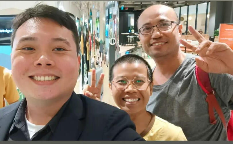 Alvin smiling with a client couple.