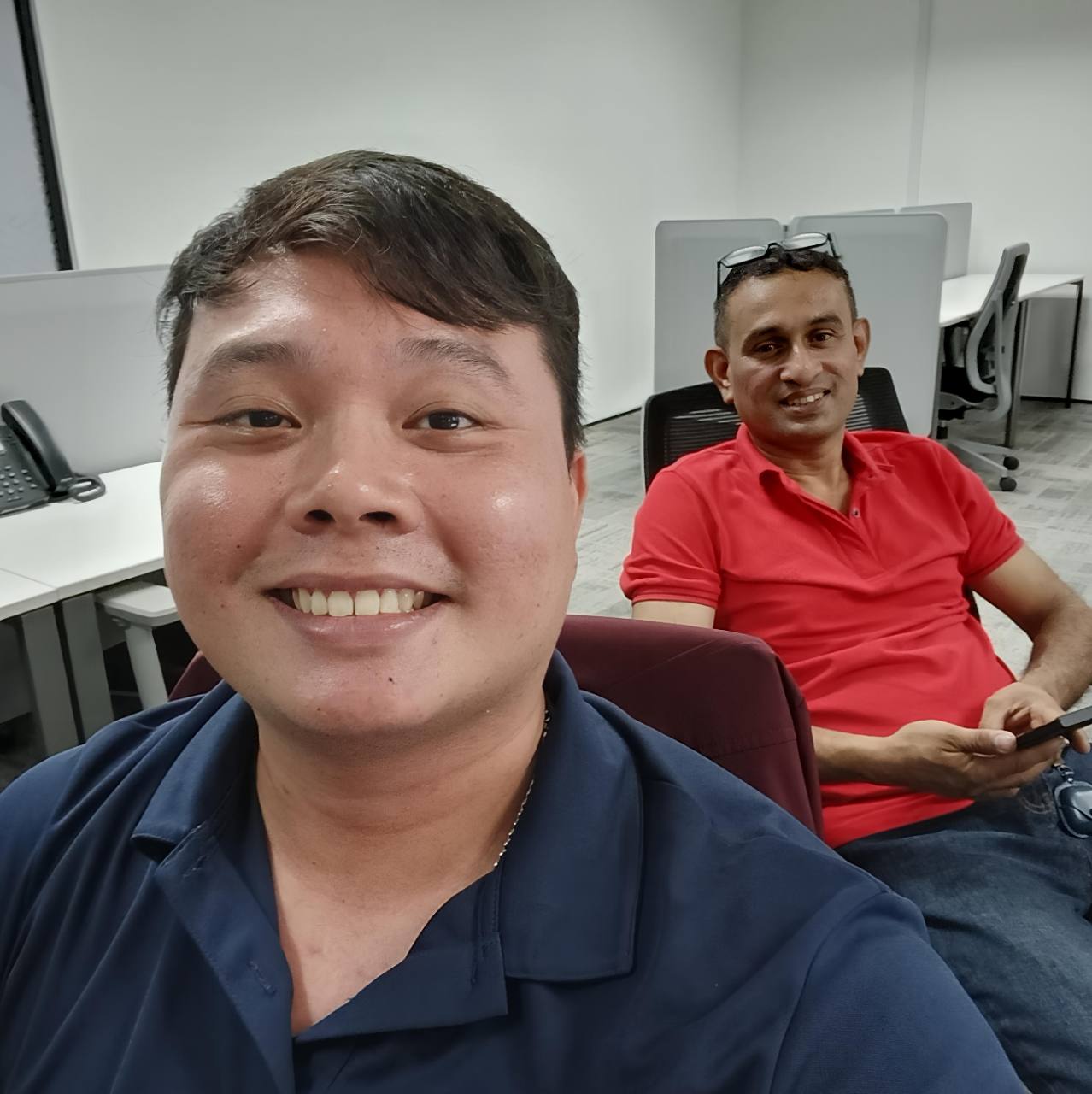 Alvin smiling with a client during an in-person office meeting.