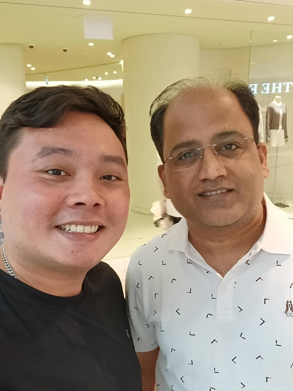 Alvin smiling together with a client.