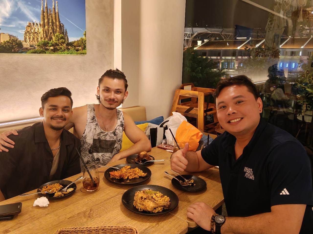 Alvin smiling together with two clients.