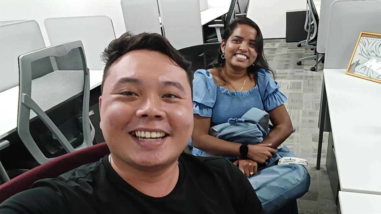 Alvin smiling with a client during an in-person meeting.